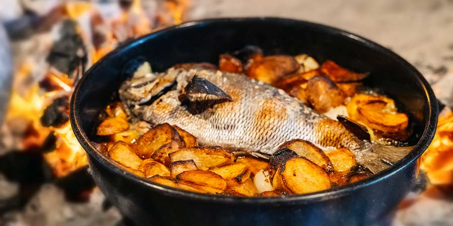 Sea Bream under the bell with potatoes